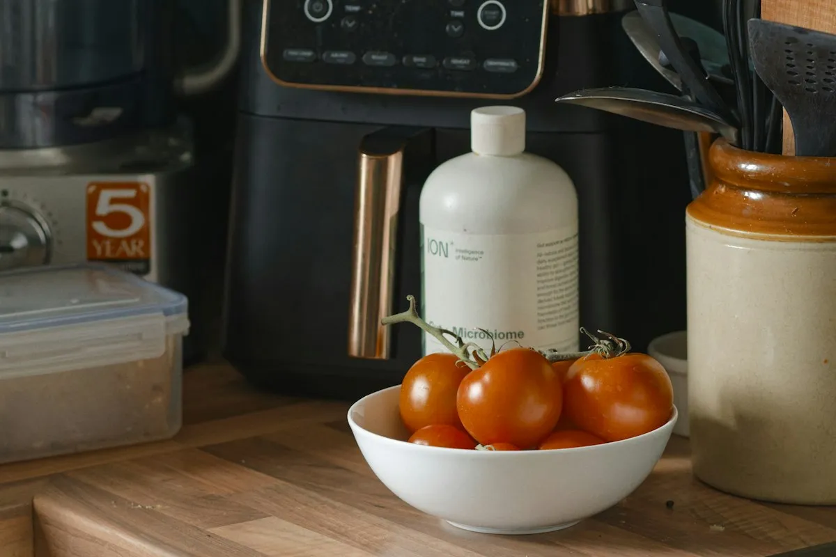 Tomatoes and small kitchen appliances on a counter