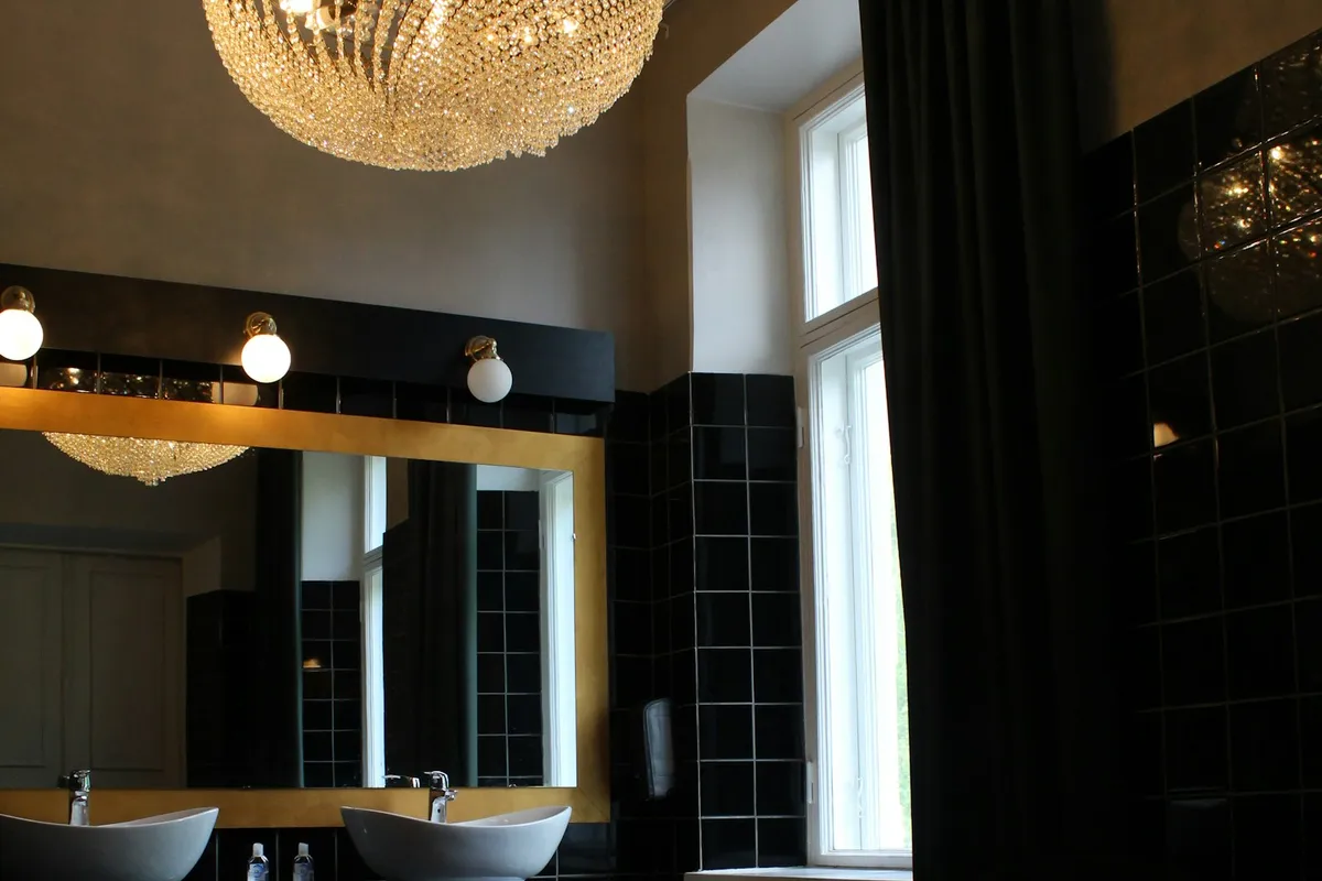A bathroom with two sinks and a large mirror