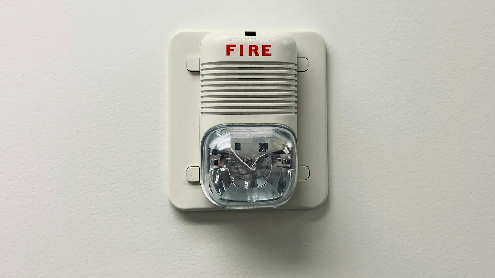 Wall-mounted fire alarm with strobe light