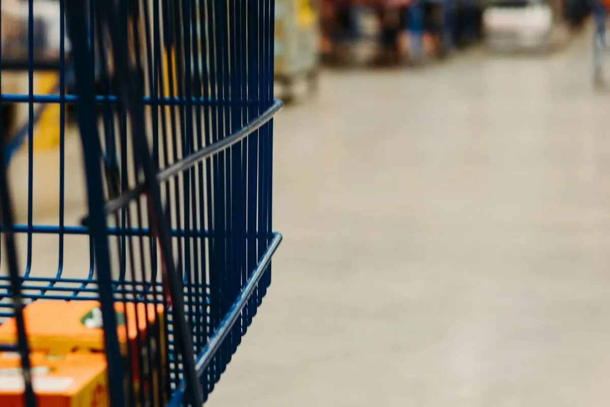 Blue shopping cart in a grocery store aisle