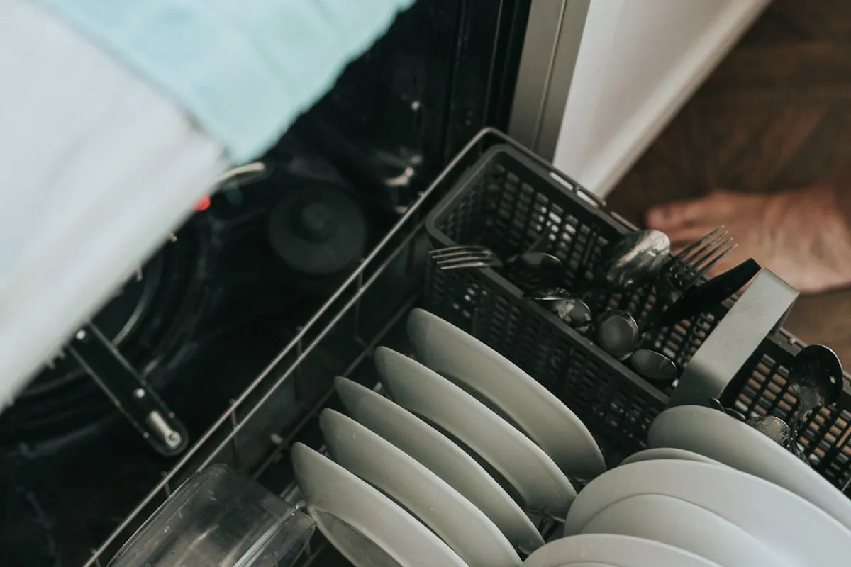 An open dishwasher rack loaded with plates