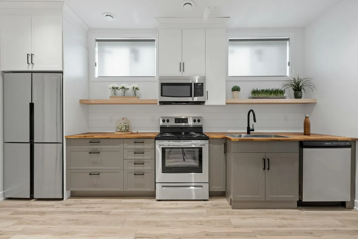 A kitchen with a stove, an over-range microwave and a built-in dishwasher