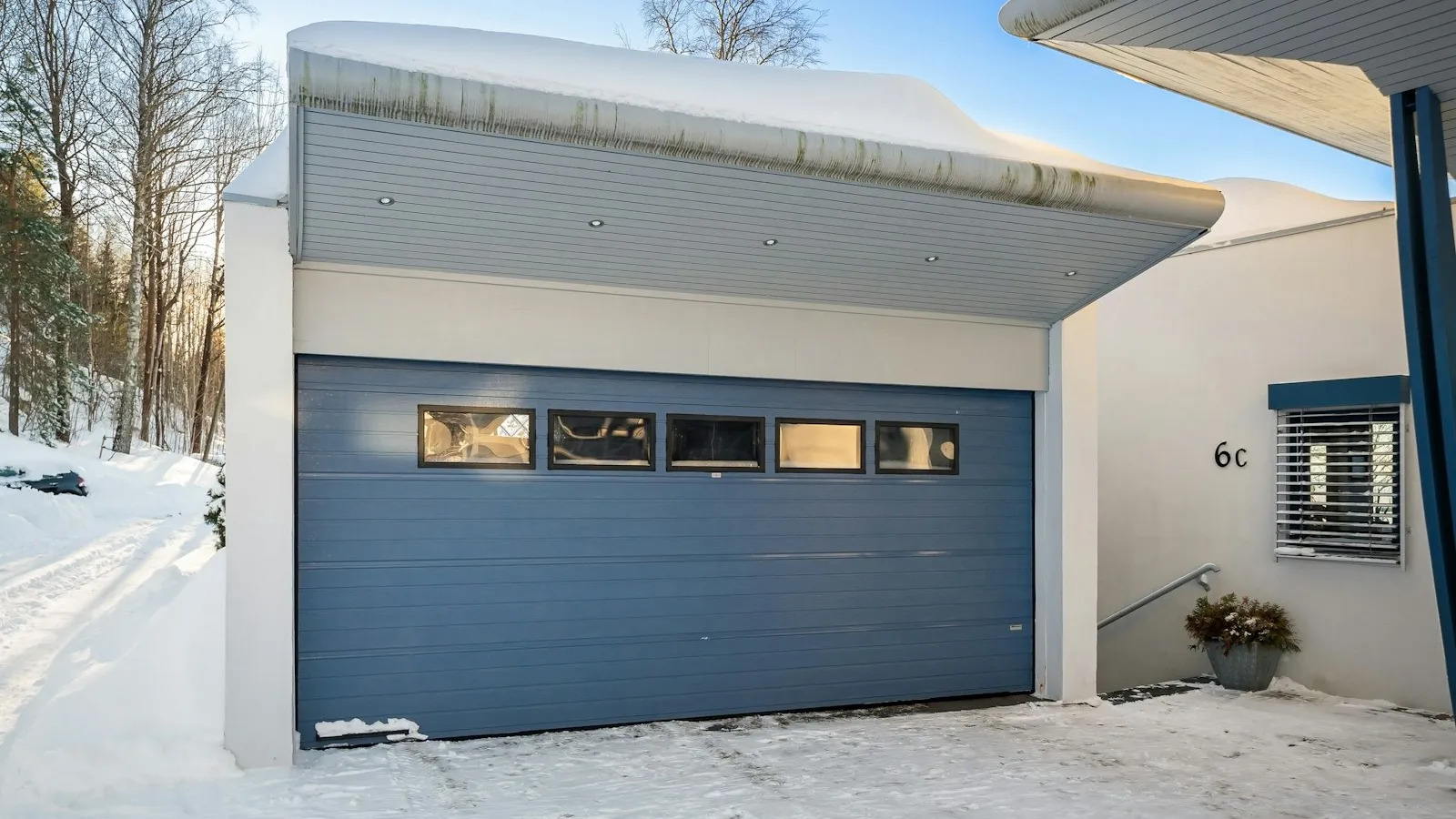 House with a closed garage door in the snow