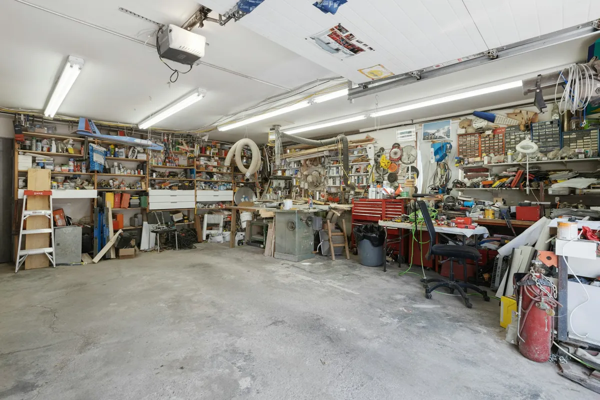 A garage with shelves and a concrete floor