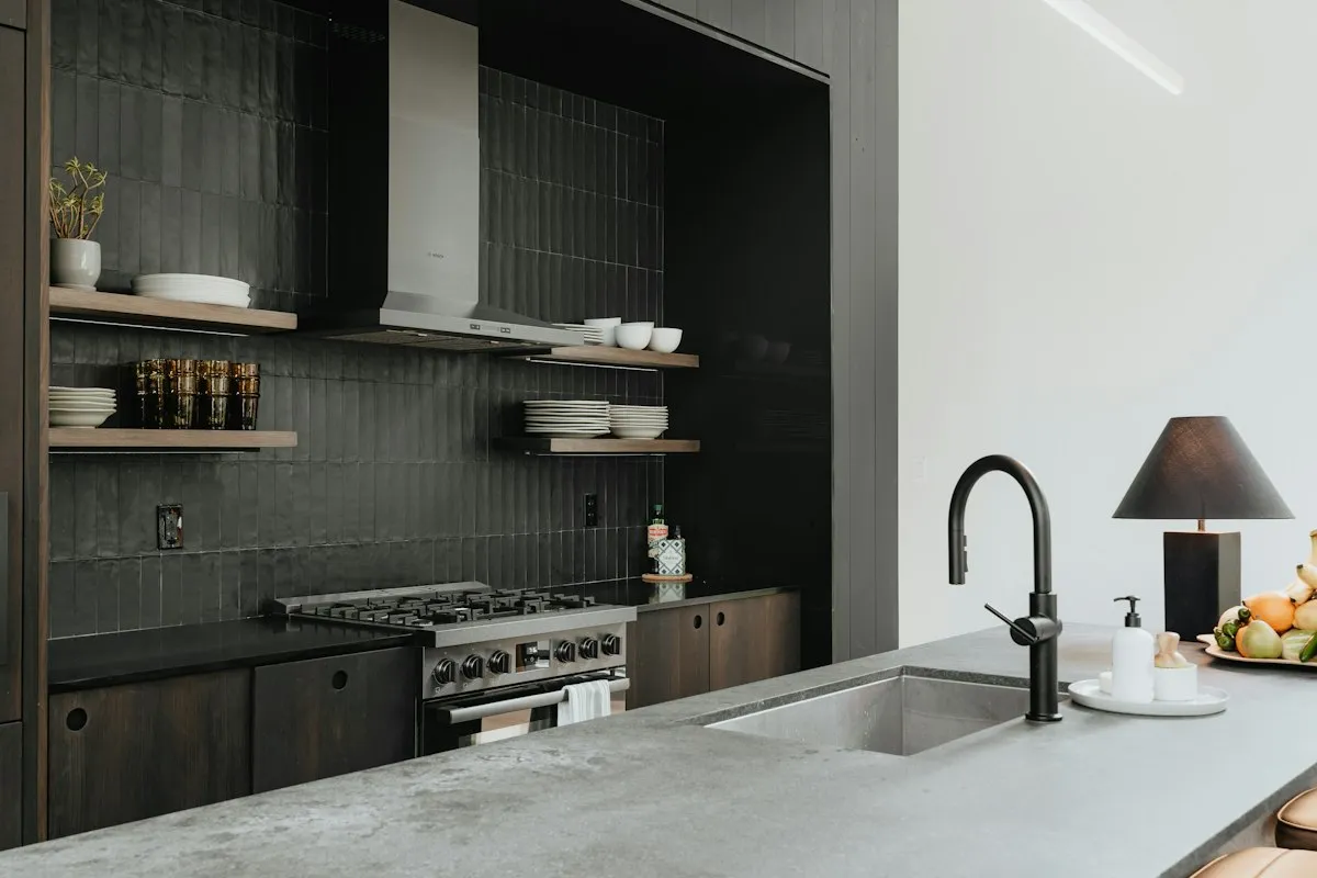 A modern kitchen with a stove, a sink and open shelves