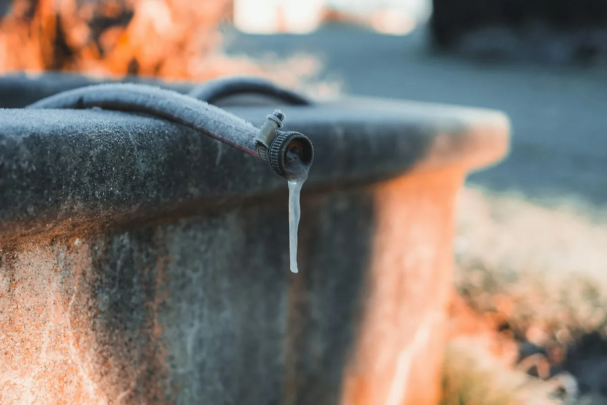 Frozen spout with an icicle forming