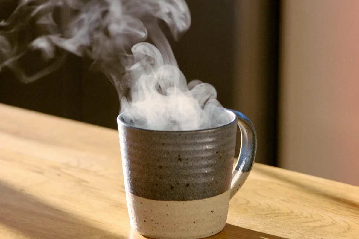 Steaming mug on a wooden table