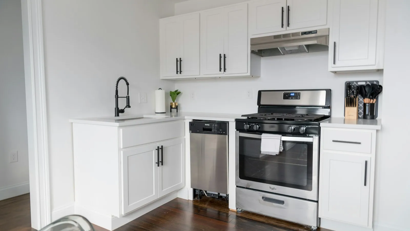 A white microwave oven on a white kitchen cabinet