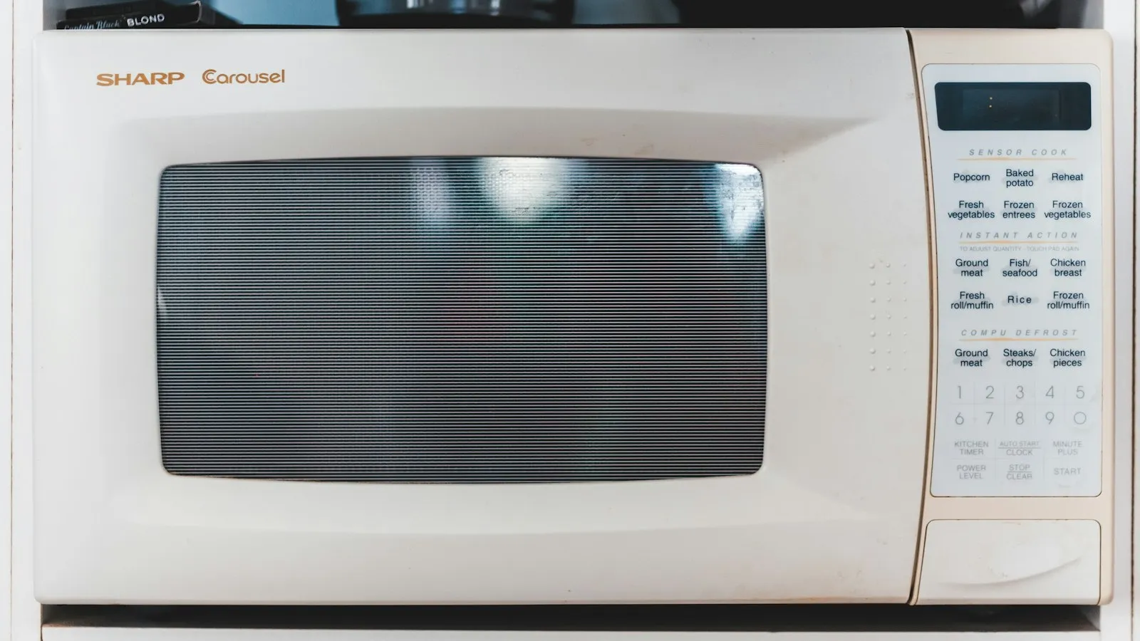 A white countertop microwave with a keypad