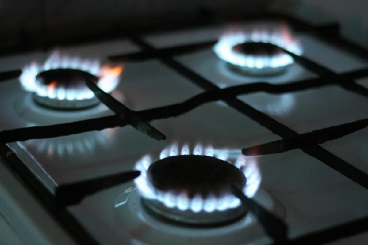 Three gas burners lit on a stove top
