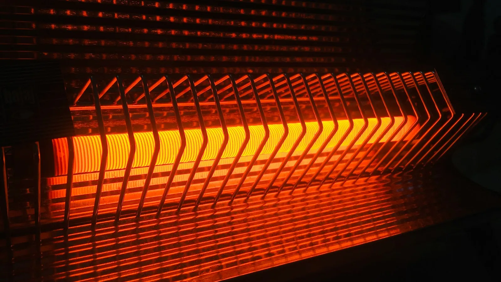 A space heater glowing orange in a dark room