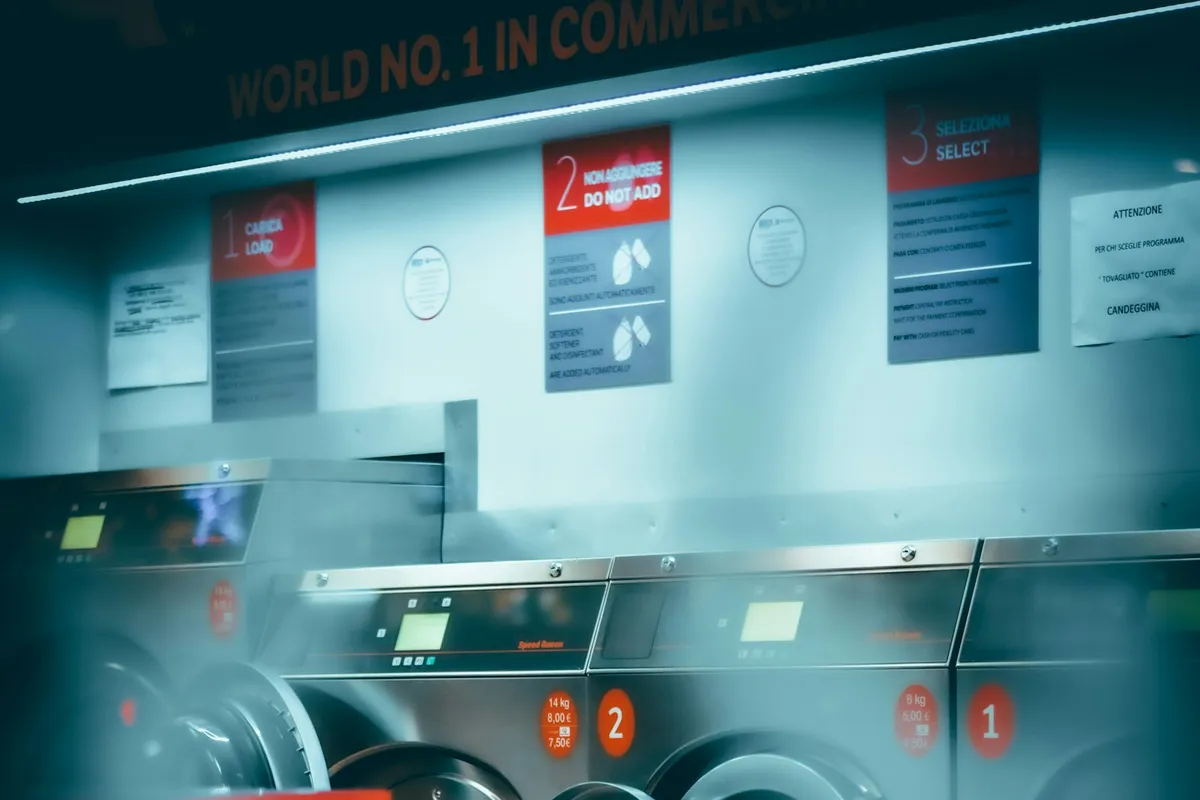 A row of front-load washing machines with their doors open